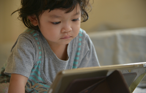 toddler on tablet device